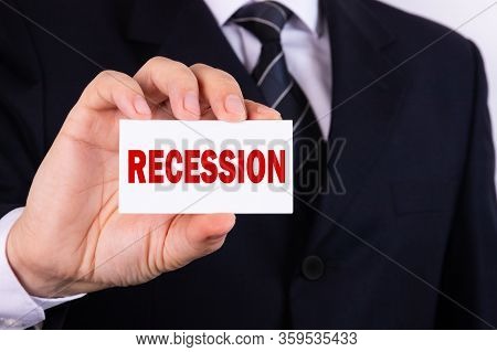 Text, The Word Recession, Written On A Tablet Held By A Businessman. Business Concept