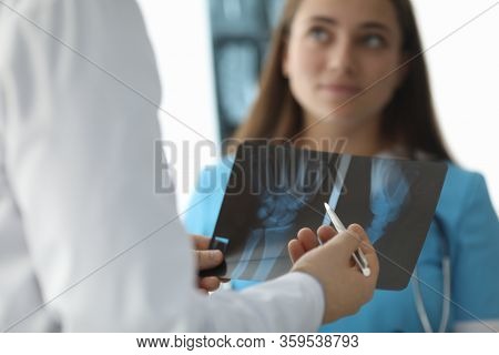 Close-up Of Doctor Hands Holding Skiagram. Surgeon Talking About Wrist Trauma. Smiling Intern Listen