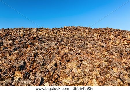 Cutted Peat Was Piled Up In A Heap After Drying. It Will Be Grounded, Packed And Then Sold As Garden