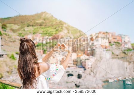 Happy Girl Making With Hands Heart Shape On The Old Coastal Village In Cinque Terre National Park.