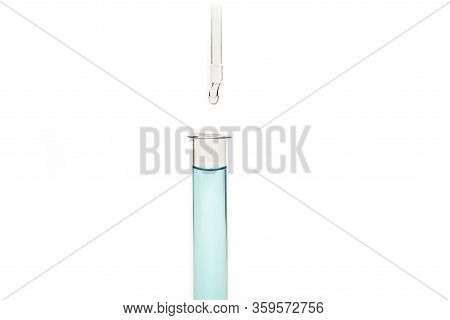 Dripping Reagent Into Test Tube With Liquid Sample
