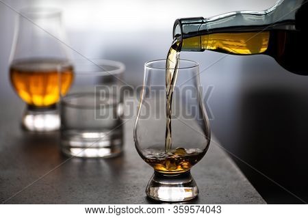 Pouring In Tulip-shaped Tasting Glass Scotch Single Malt Or Blended Whisky