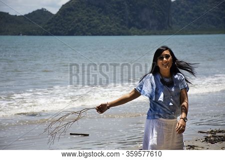 Traveler Thai Women Relax On The Beach And Portrait Posing For Take Photo With Wave Water Of Sea And