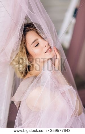 A Portrait Of Young Beautiful Woman With Blonde Hair In Pink Voile. Natural Beauty
