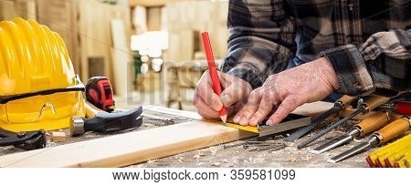 Carpenter At Work On Wooden Boards. Carpentry.