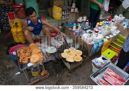 Ho Chi Minh, Vientam - August 25, 2017: Man Cooking Traditional Vietnamese Fried Snack In Street Foo