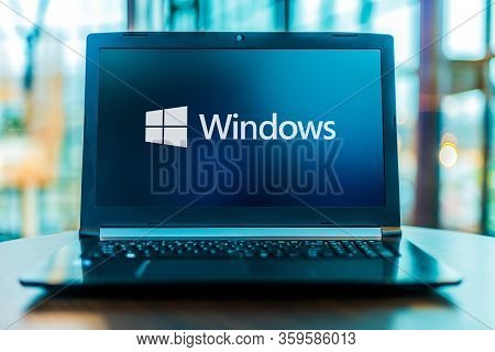 Poznan, Pol - Mar 24, 2020: Laptop Computer Displaying Logo Of Windows, A Group Of Several Graphical
