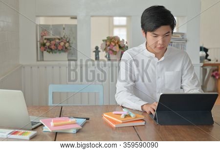 Male Students Are Using Laptop To Study Summer Online At Home,work At Home,work From Home.