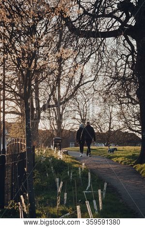 London, Uk - March 22,2020: Couple Walking A Dog In Broomfield Park, Public Park In Palmers Green In