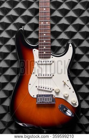 Top View Of Electric Guitar On Acoustic Foam Panel Background