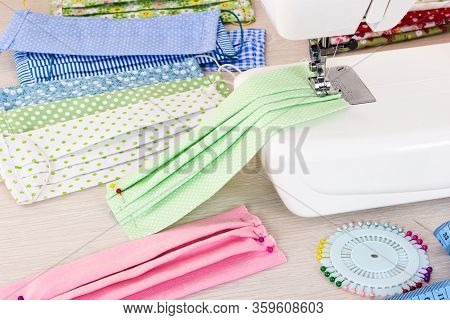 Sewing Reusable Fabric Masks At Home For Coronavirus Protection. Handmade Multicolored Fabric Face M