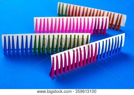 On A Blue Background Hair Clips Of Different Colors In Sets On A Cardboard Frame