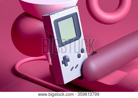 Retro Video Game Console On Abstract Juicy Background Of Pink And Pupur Vivid Colors. 3d Rendering