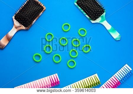 On A Blue Background Are Combs Hair Clips Elastic Bands, Hairdressing Accessories, Top View