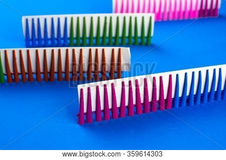 On A Blue Background Hair Clips Of Different Colors In Sets On A Cardboard Frame