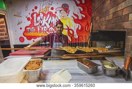 Istanbul, Turkey: Chef Of Bakery Making A Turkish Pizza Or Lahmacun. Dough, Minced Meat And Vegetabl