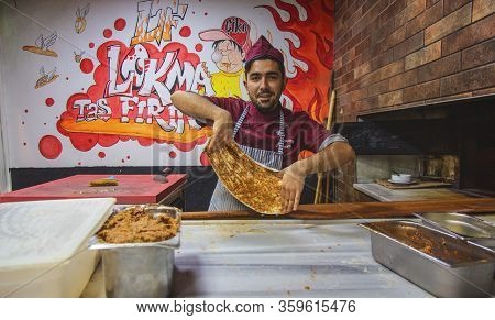 Istanbul, Turkey: Chef Of Bakery Making A Turkish Pizza Or Lahmacun. Dough, Minced Meat And Vegetabl