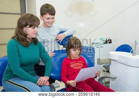 A Happy Family In A Dental Office. A Family Visit To A Dentis