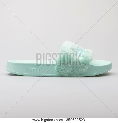 Vienna, Austria - August 15, 2017: Puma Fur Slide Green Sandals On White Background.