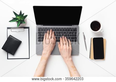 Worktime. Closeup Top View Of Woman Working On Laptop While Sitting At Home Office, Blank Screen