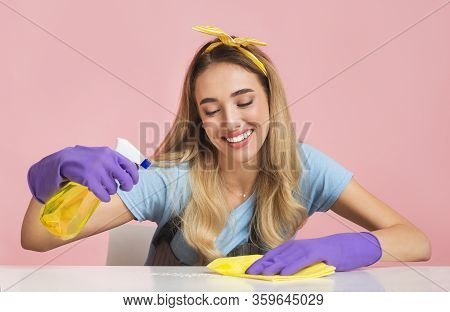 House Cleaning With Smile. Housewife Wipes Dust On Table