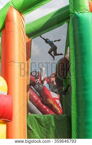 Atlanta, Ga/usa - August 10:  A Boy Jumps Into A Soft Plastic Pit From A Two-story Height On A Giant