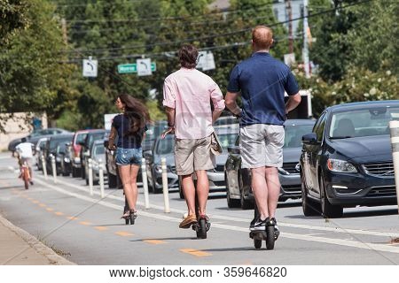 Atlanta, Ga/usa - August 10: Several People On Motorized Scooters Ride Through The Bike Lane On A St