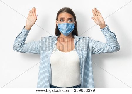 Coronavirus Quarantine Breaker. Woman In Mask Raising Hands Caught On Breaking Self-quarantine Rules