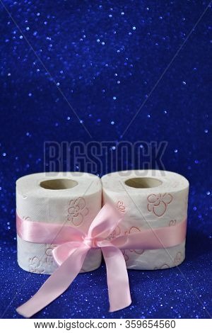 Rolls Of Toilet Paper On Glitter Blue Background