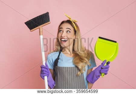 Funny Blonde Lady Is Engaged Home Cleaning With Broom And Shovel