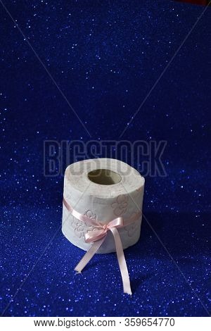 Roll Of Toilet Paper On Glitter Blue Background