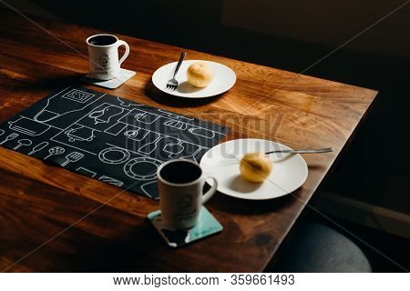 Table Setting For Breakfast - Plate, Fork, Cup On The Wooden Table.
