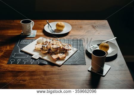 Table Setting For Breakfast - Plate, Fork, Cup And Toast On The Wooden Table.