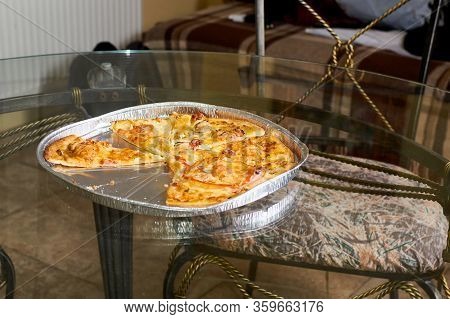 Freshly Cooked Pieces Of Pizza Lying On The Glass Table.