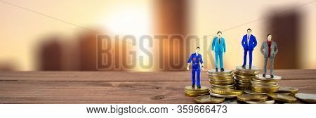 Miniature People: Businessmenstanding On Stack Of Coins With Some Coins, City Backround. Thay Are Ri