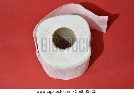 Roll Of Toilet Paper On Red Background