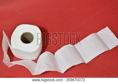 Roll Of Toilet Paper On Red Background
