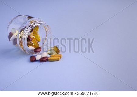 Food Supplements In Glass Bottle In Blue Background