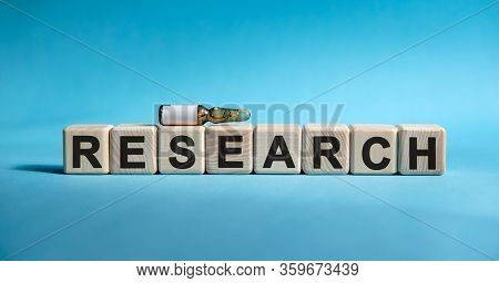 Research- Word On Cubes. Drug In Ambula To Reduce Disease Symptoms On A Blue Background