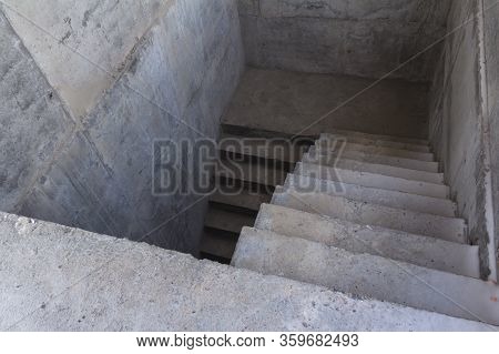 A Ladder Of Concrete Leading Down. Concrete Steps. Stairs Down
