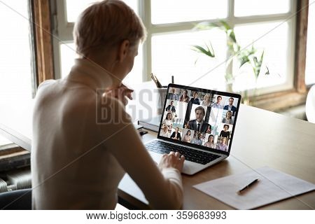 Woman Sitting At Desk Watching New Videoconference Application Online Review