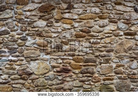 A Stone Wall Of A Small Building