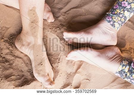 Slack Feet On The Desert Sand In M'hamid El Ghizlane.