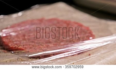 Cook Makes Meat Medallions For Burgers. Chef In Black Food Gloves Makes Cutlet. Cutlets Are Leveled 