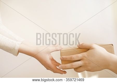 Delivery Woman Holding Box Or Package. Close-up. White Background. Copy Space.