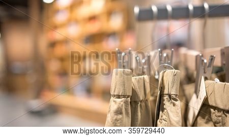 Modern Fashion Women Clothes Hang On Stanless Steel Hangers Rack At Cloth Shop Department Store. Cas