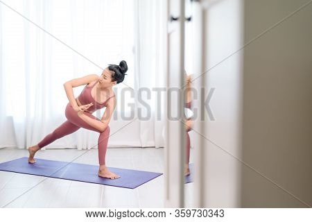 Young Woman Do Yoga In A Bed Room