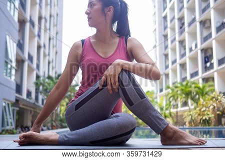 Young Women Are Doing Seated Twist Exercises For Health And A Firmer Body. Exercise And Relax Muscle