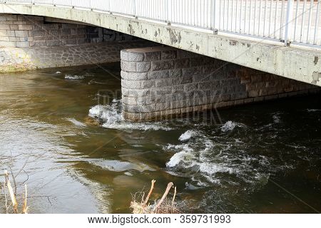 The Rapid Flow Of The River Under The Bridge