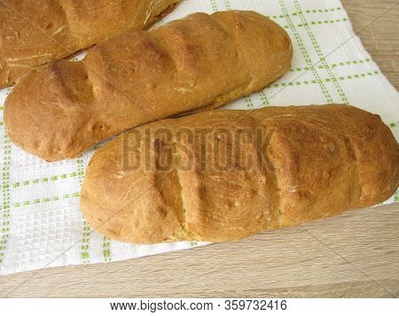 Freshly Baked Spelt Baguette On A Dishtowel